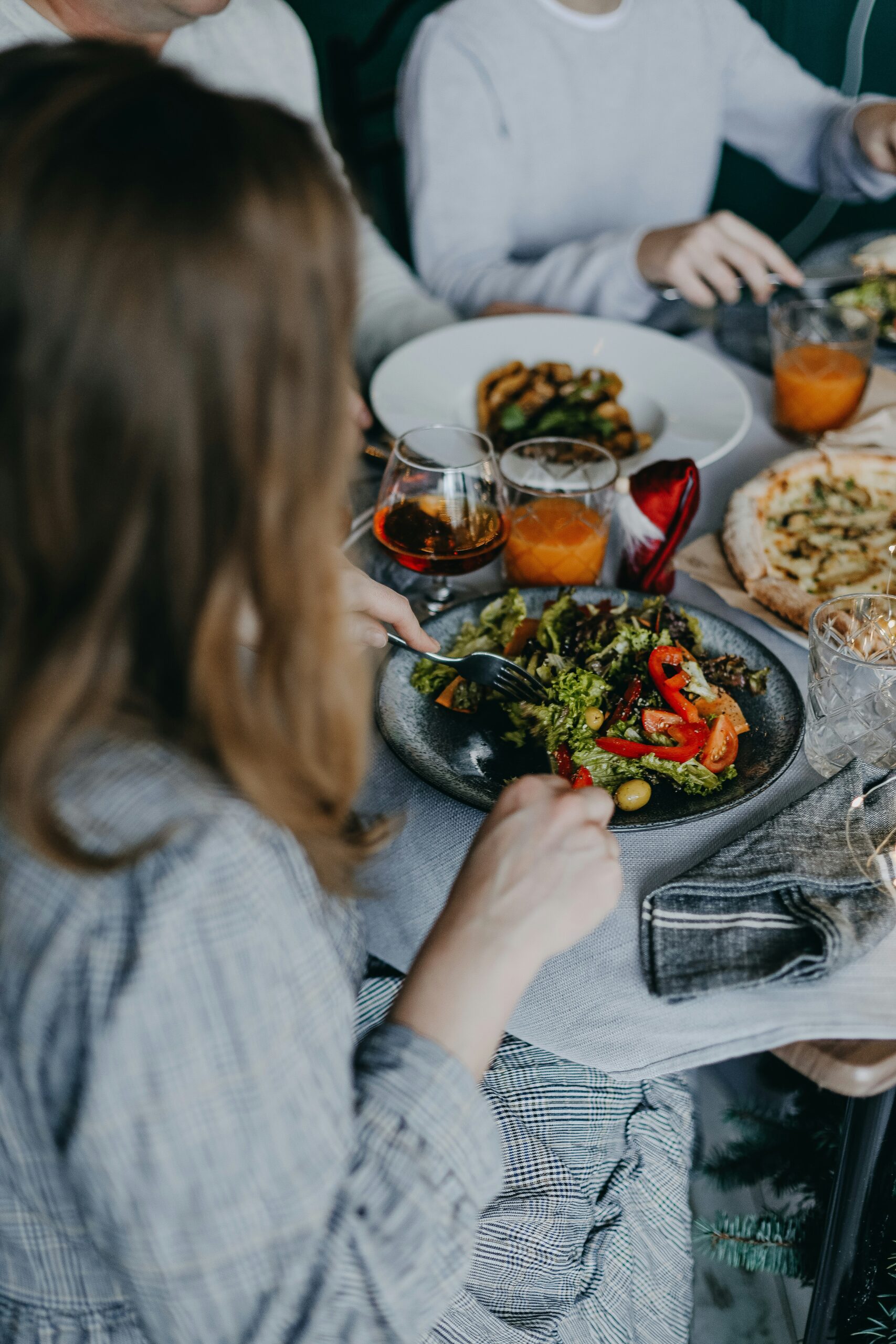 woman eating plate of healthy food